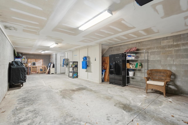 garage featuring black fridge