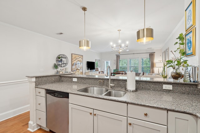 kitchen with light stone counters, stainless steel dishwasher, crown molding, and sink