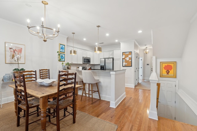 dining room featuring ornamental molding and light hardwood / wood-style flooring