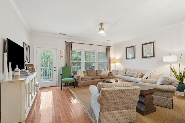 living room featuring crown molding, ceiling fan, and light hardwood / wood-style flooring