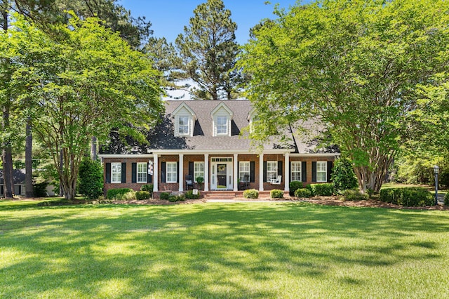 1096 Dunham Rd, Orangeburg, SC 29118 - cape cod home with covered porch, brick siding, and a front yard