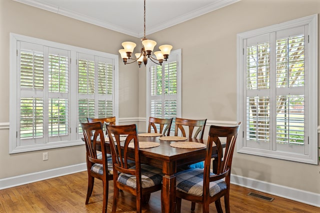 1096 Dunham Rd, Orangeburg, SC 29118 - dining space featuring wood finished floors, visible vents, a chandelier, crown molding, and baseboards