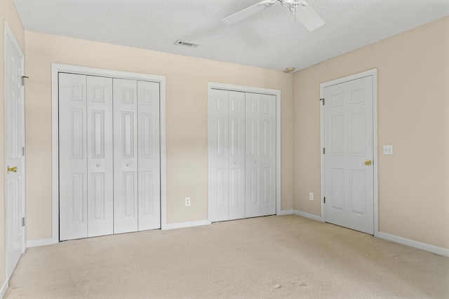 1096 Dunham Rd, Orangeburg, SC 29118 - unfurnished bedroom with baseboards, multiple closets, visible vents, and light colored carpet