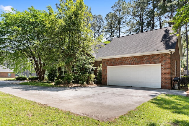 1096 Dunham Rd, Orangeburg, SC 29118 - view of front of home with driveway, roof with shingles, brick siding, and an attached garage