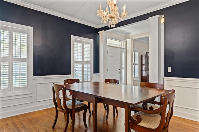 1096 Dunham Rd, Orangeburg, SC 29118 - dining room featuring wood finished floors, a wainscoted wall, a notable chandelier, crown molding, and a decorative wall
