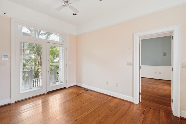 doorway with ceiling fan and hardwood / wood-style flooring