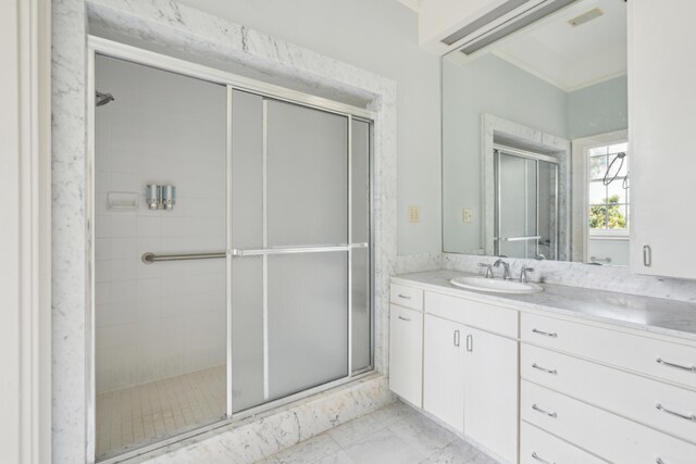 bathroom featuring ornamental molding, vanity, tile patterned floors, and a shower with door