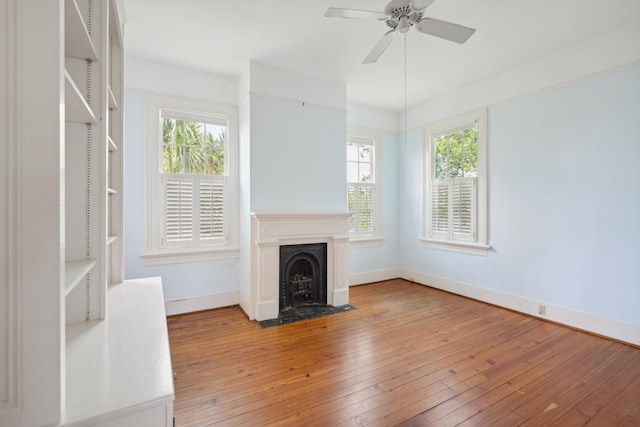 unfurnished living room with ceiling fan and light hardwood / wood-style flooring