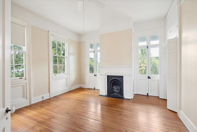 unfurnished living room featuring plenty of natural light and light wood-type flooring