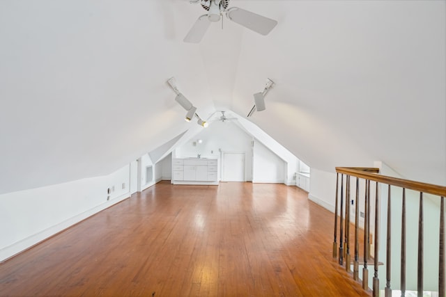 additional living space with lofted ceiling, ceiling fan, and wood-type flooring