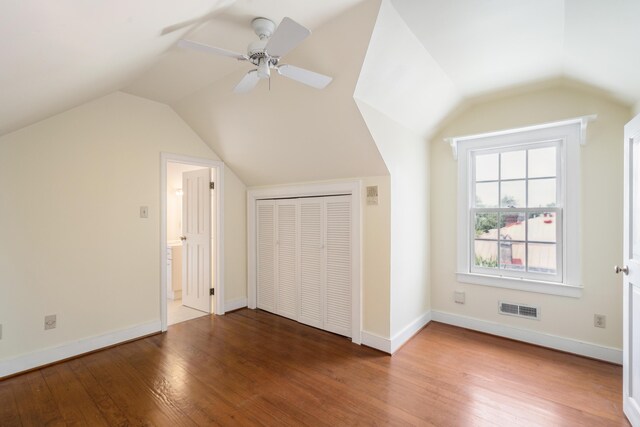 additional living space with wood-type flooring, vaulted ceiling, and ceiling fan