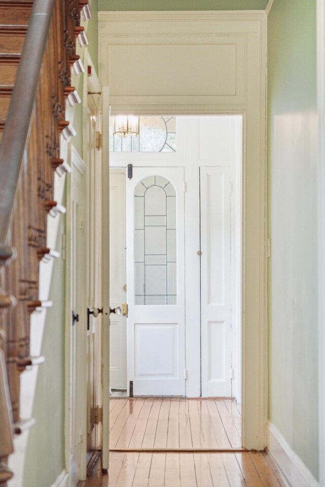 entryway featuring crown molding and light hardwood / wood-style flooring