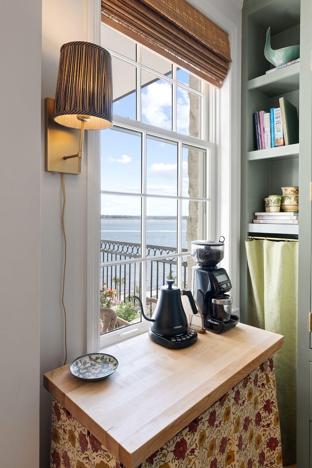 dining space with a water view and built in shelves