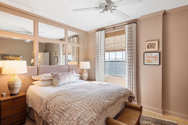 bedroom featuring crown molding, a ceiling fan, and baseboards