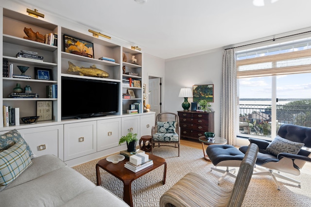 living room featuring ornamental molding and wood finished floors