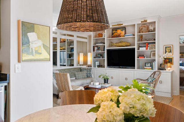 interior space with built in shelves and wood finished floors