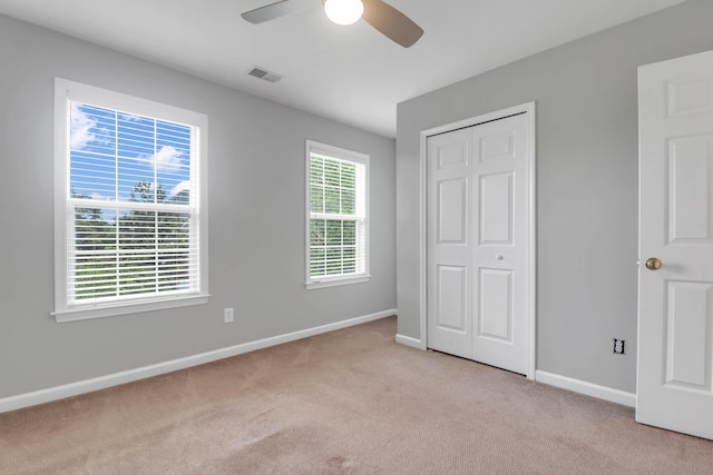 200 Oak Point Landing Dr, Mount Pleasant, SC 29464 - unfurnished bedroom with light colored carpet, baseboards, a closet, and a ceiling fan