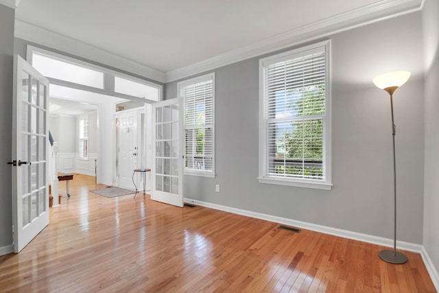 200 Oak Point Landing Dr, Mount Pleasant, SC 29464 - empty room featuring french doors, crown molding, wood-type flooring, and healthy amount of natural light