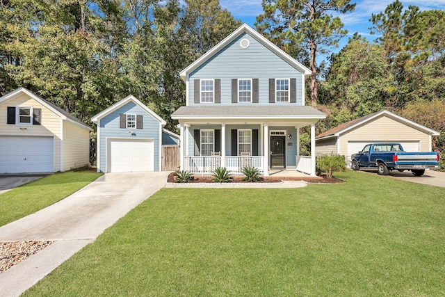 view of front property featuring a porch, a garage, an outbuilding, and a front lawn