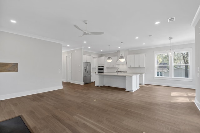 kitchen with visible vents, appliances with stainless steel finishes, open floor plan, and light countertops