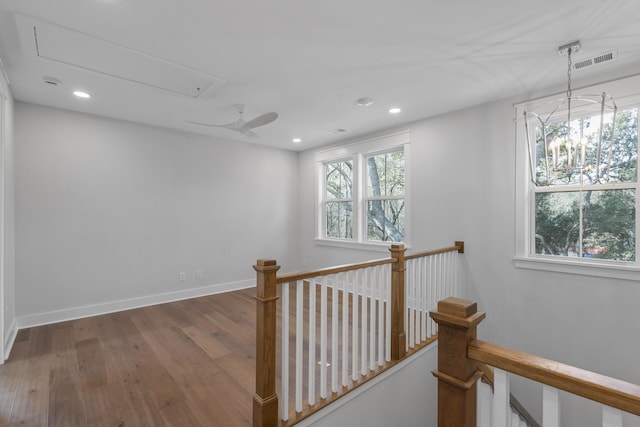 hallway featuring plenty of natural light, attic access, visible vents, and an upstairs landing