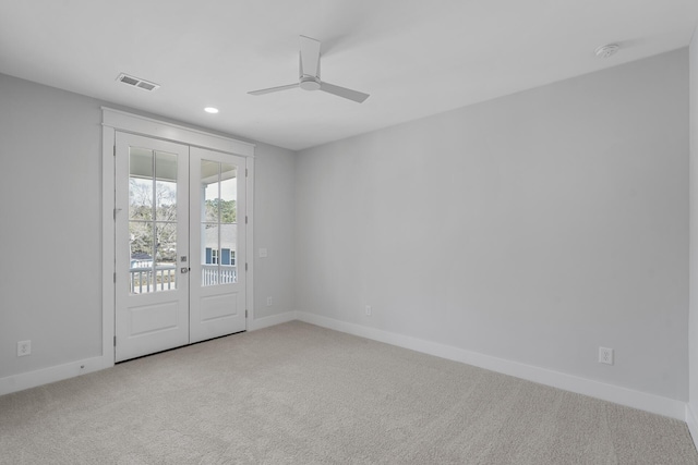 unfurnished room with carpet, visible vents, and baseboards