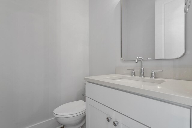 bathroom featuring vanity and toilet