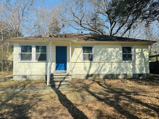 view of front of home with crawl space, roof with shingles, and entry steps