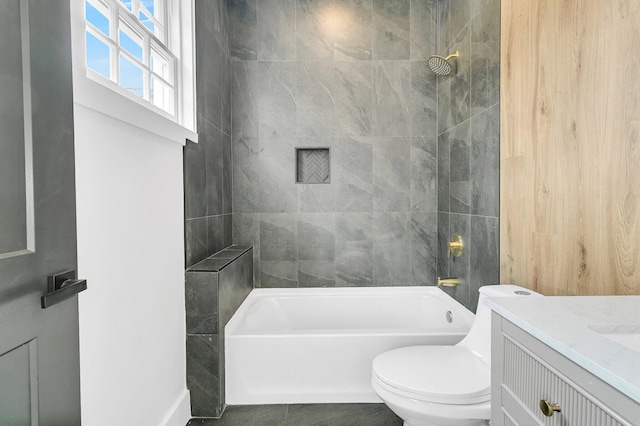 full bathroom with vanity, tiled shower / bath combo, and toilet