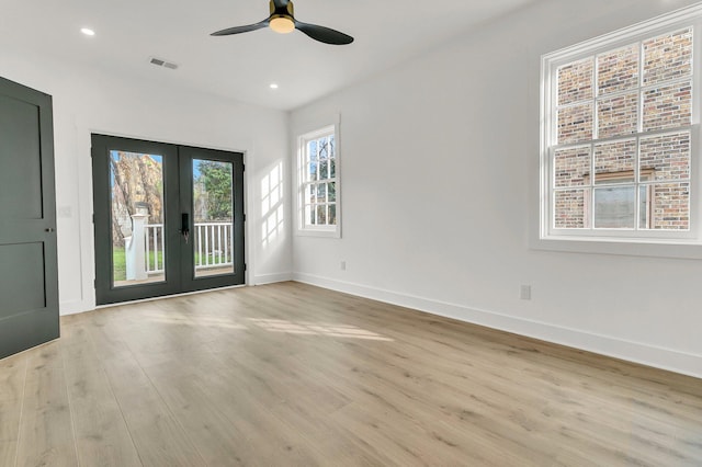 empty room featuring ceiling fan, light hardwood / wood-style flooring, and french doors