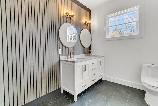 bathroom featuring tile patterned floors, vanity, wood walls, and toilet