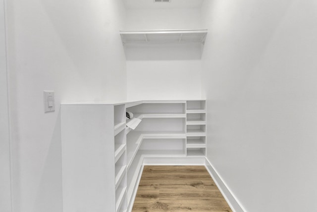 walk in closet featuring hardwood / wood-style floors