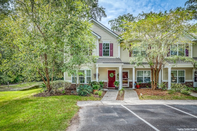 view of property featuring a front lawn