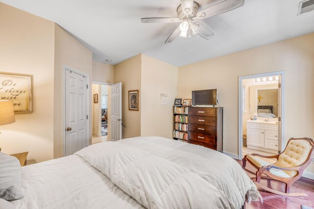 bedroom with light hardwood / wood-style flooring, connected bathroom, and ceiling fan