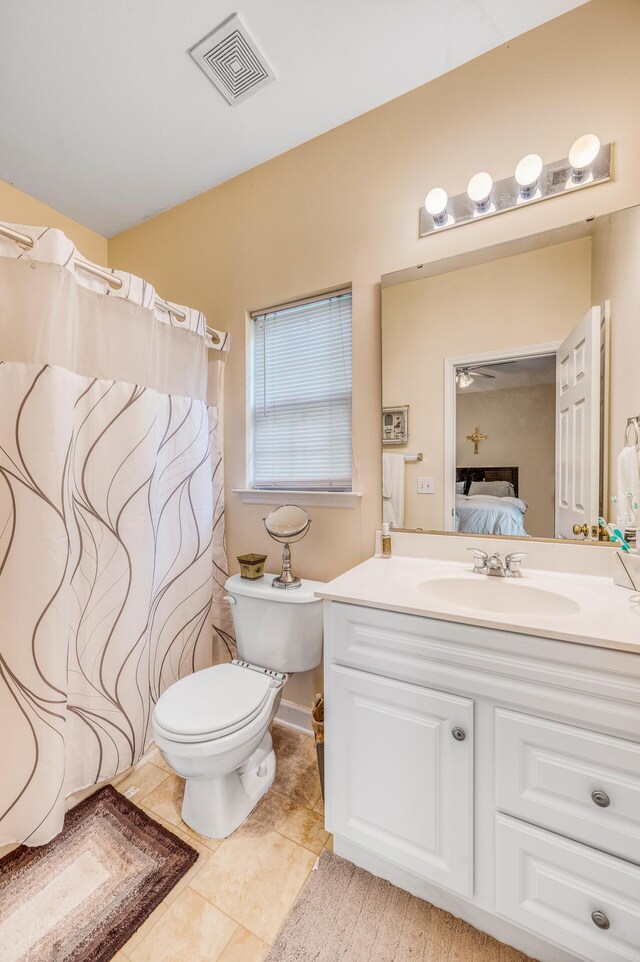 bathroom featuring vanity, toilet, walk in shower, and tile patterned flooring