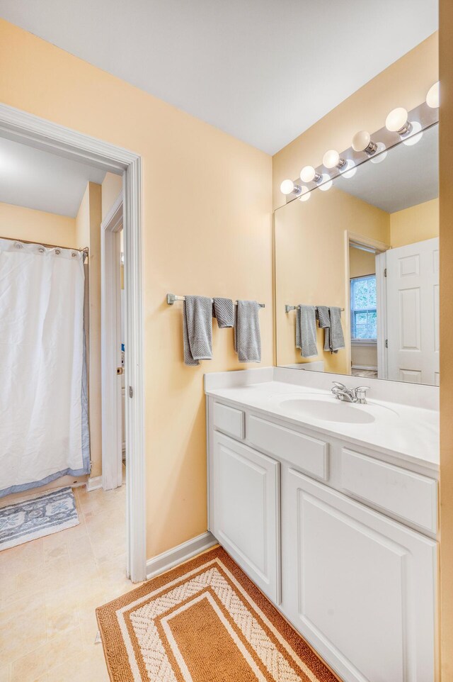 bathroom with a shower with shower curtain, tile patterned flooring, and vanity