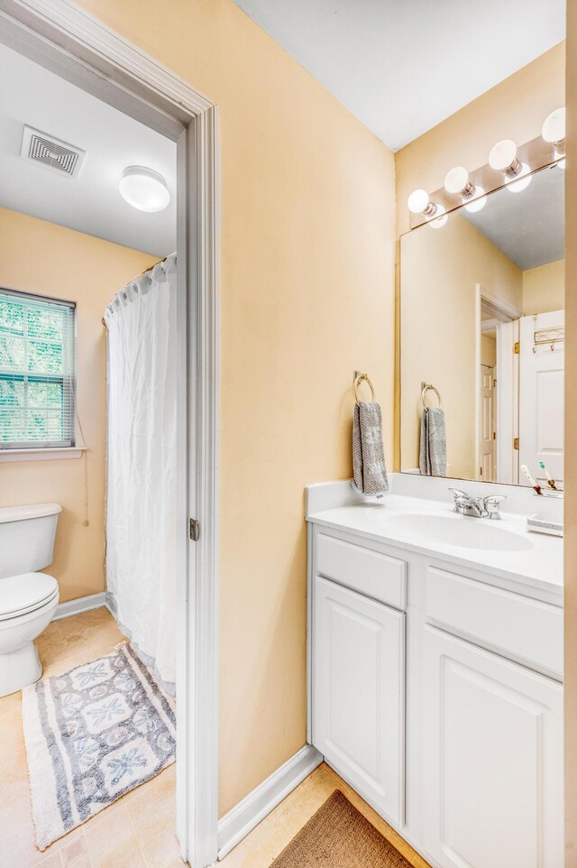 bathroom with vanity, toilet, and walk in shower