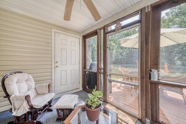 sunroom / solarium featuring ceiling fan and a wealth of natural light