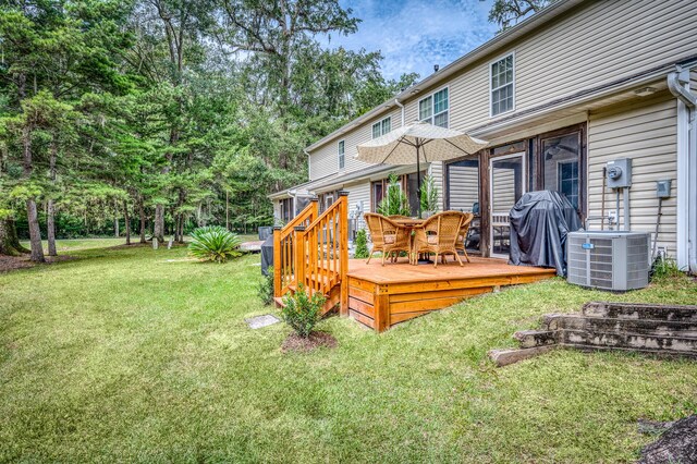 view of yard featuring cooling unit and a deck