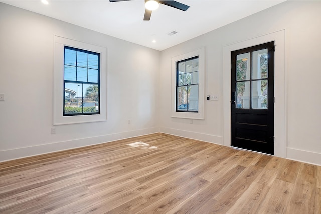 entrance foyer featuring ceiling fan, a healthy amount of sunlight, and light hardwood / wood-style flooring