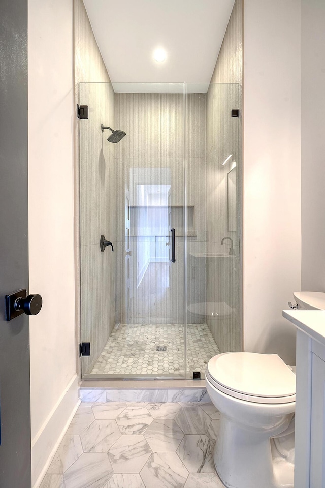 bathroom with vanity, an enclosed shower, and toilet