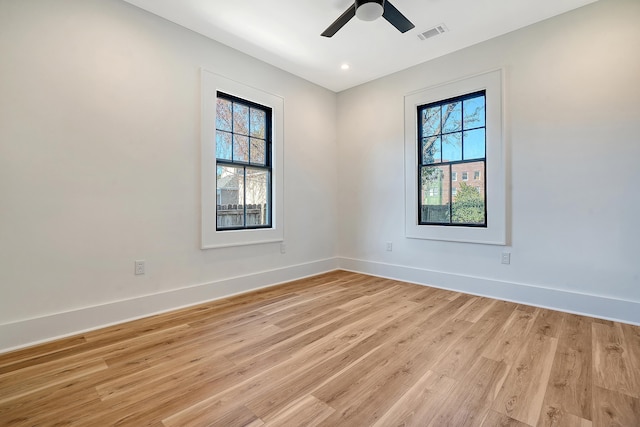 spare room featuring ceiling fan and light hardwood / wood-style flooring