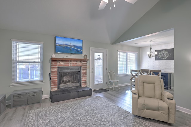 living room featuring hardwood / wood-style flooring, vaulted ceiling, and plenty of natural light