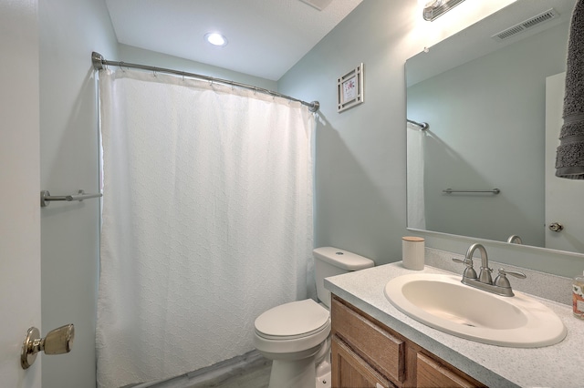 bathroom featuring vanity, hardwood / wood-style flooring, and toilet