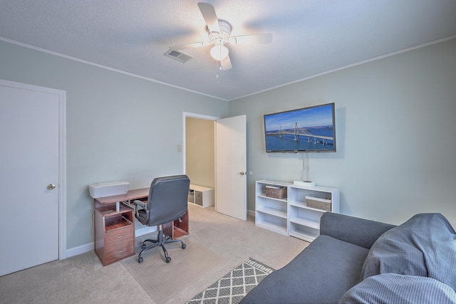 office space with a textured ceiling, light colored carpet, and ceiling fan