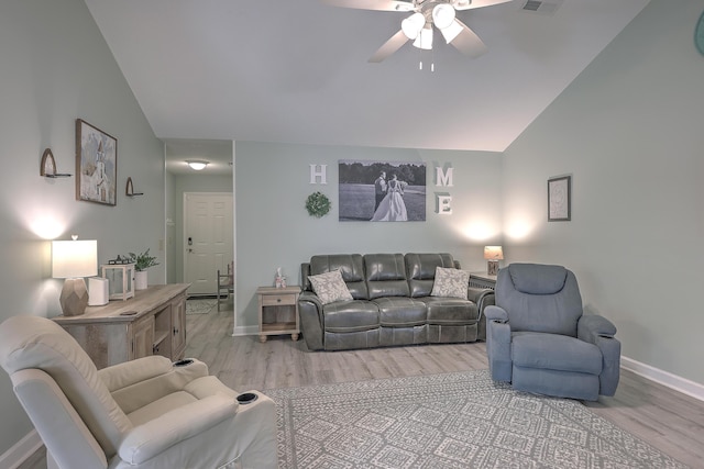 living room featuring ceiling fan, light hardwood / wood-style flooring, and vaulted ceiling