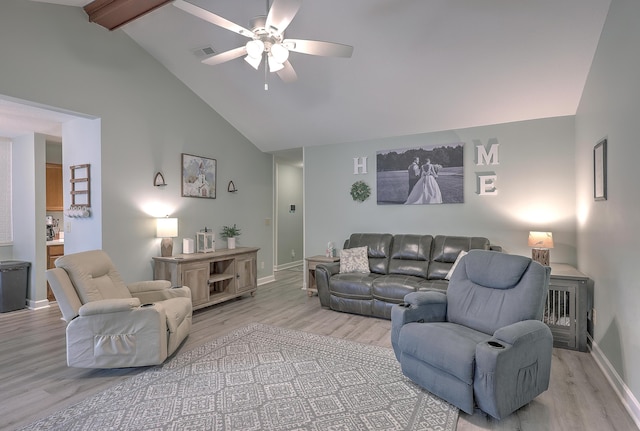 living room with ceiling fan, beamed ceiling, light hardwood / wood-style floors, and high vaulted ceiling