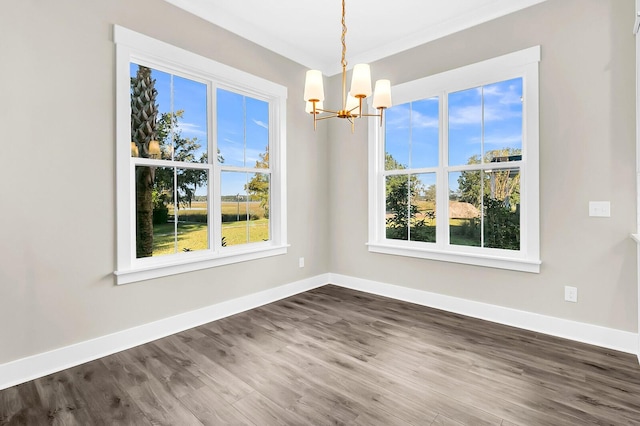 unfurnished dining area with an inviting chandelier and hardwood / wood-style floors