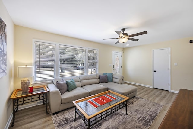 living room with hardwood / wood-style floors and ceiling fan