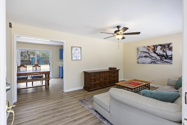 living room with hardwood / wood-style flooring and ceiling fan